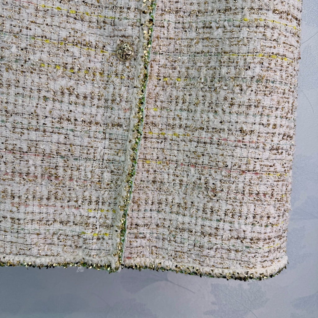 A light beige tweed blend short-sleeved jacket