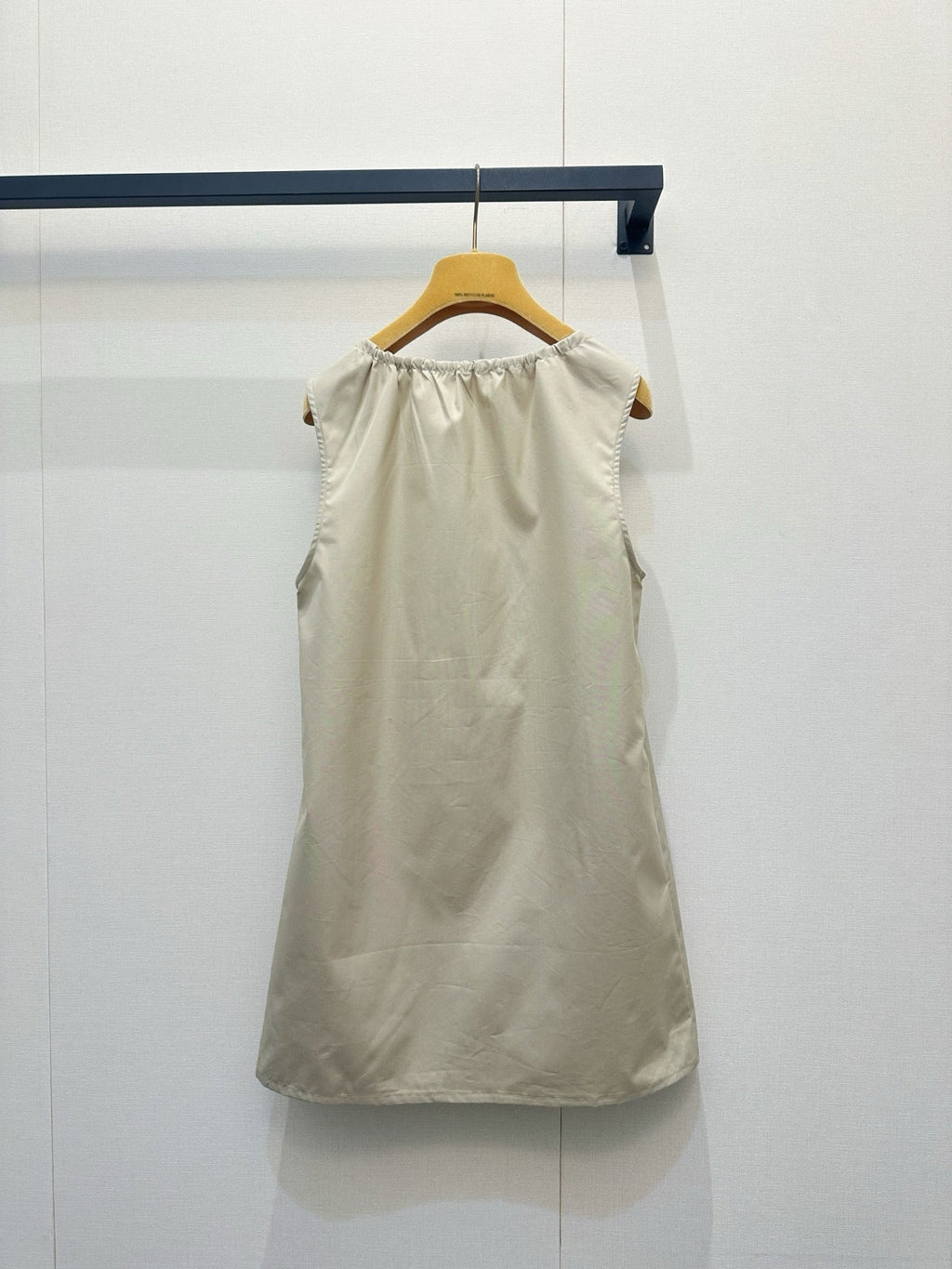 Beige vest dress with contrasting leather label