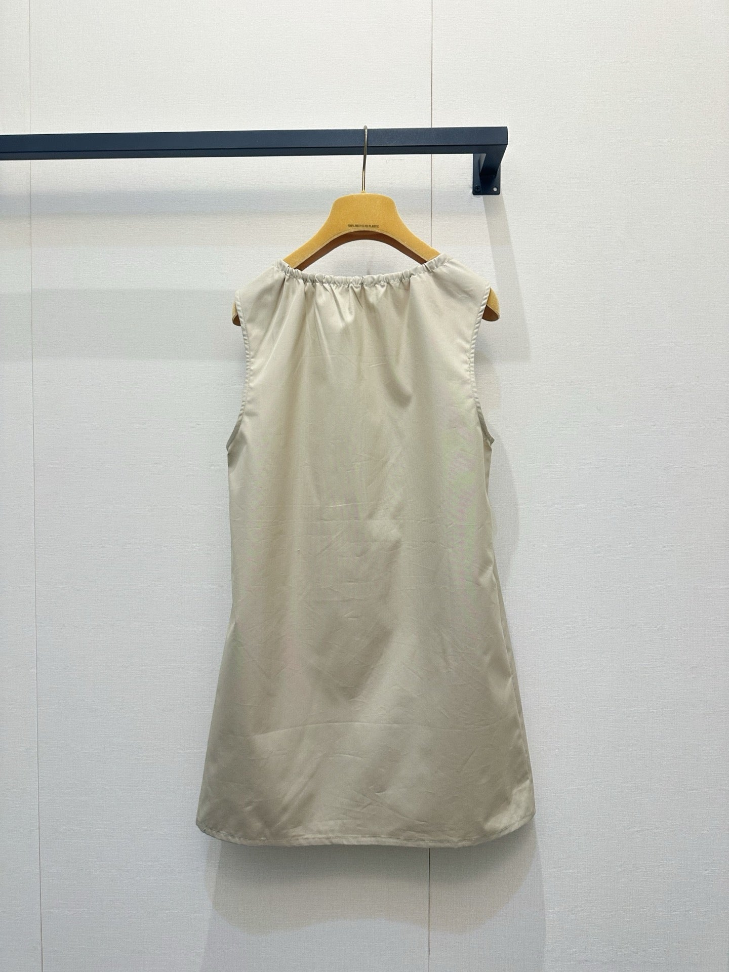 Beige vest dress with contrasting leather label