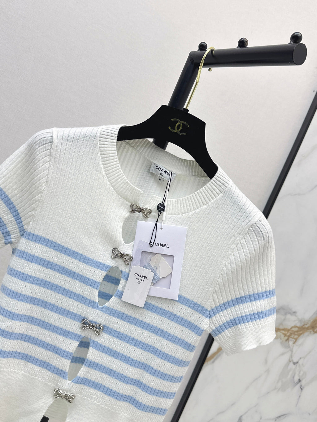 Striped knit top with bow embellishment
