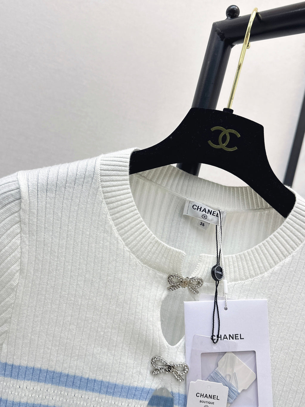 Striped knit top with bow embellishment