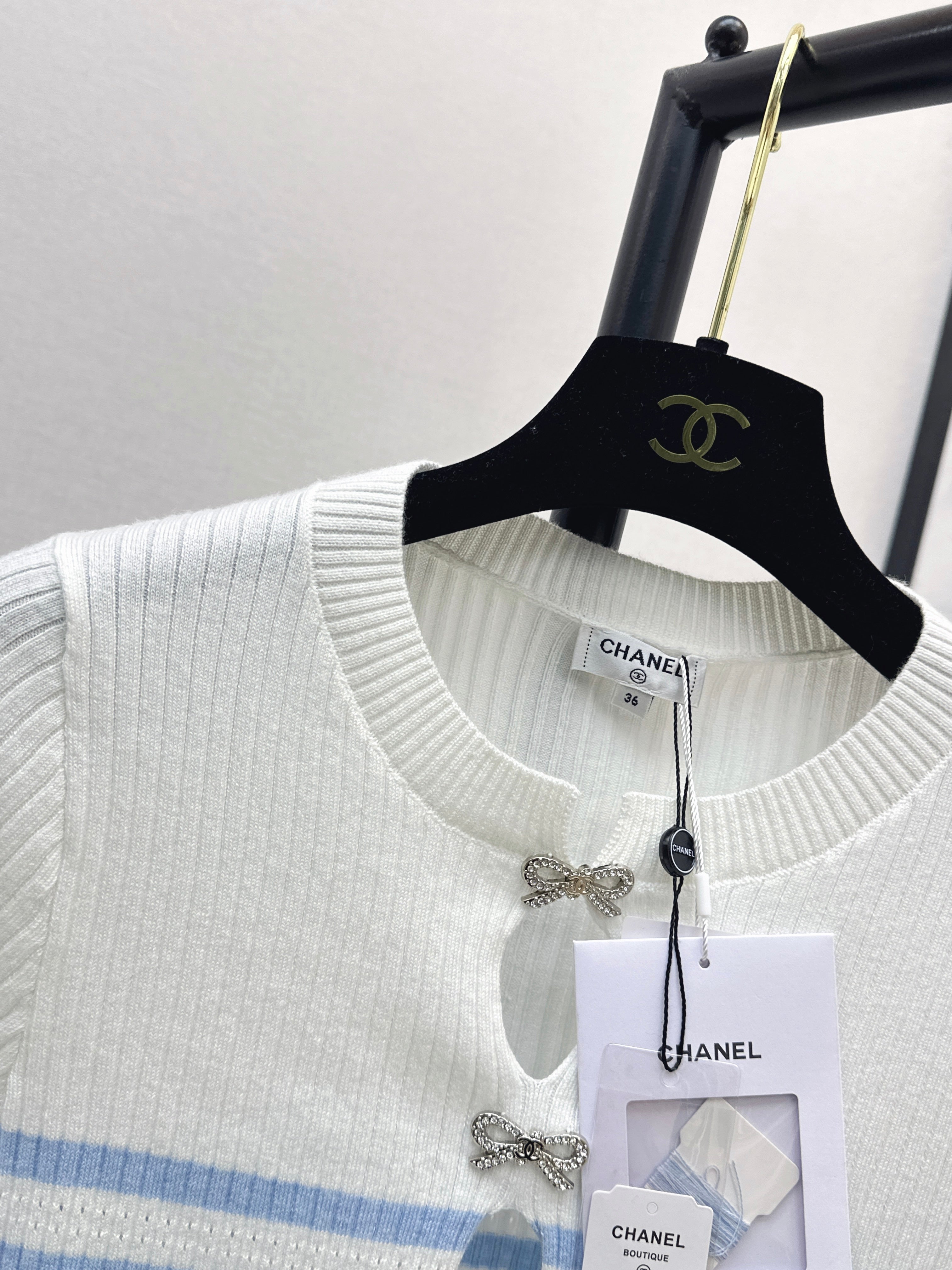 Striped knit top with bow embellishment