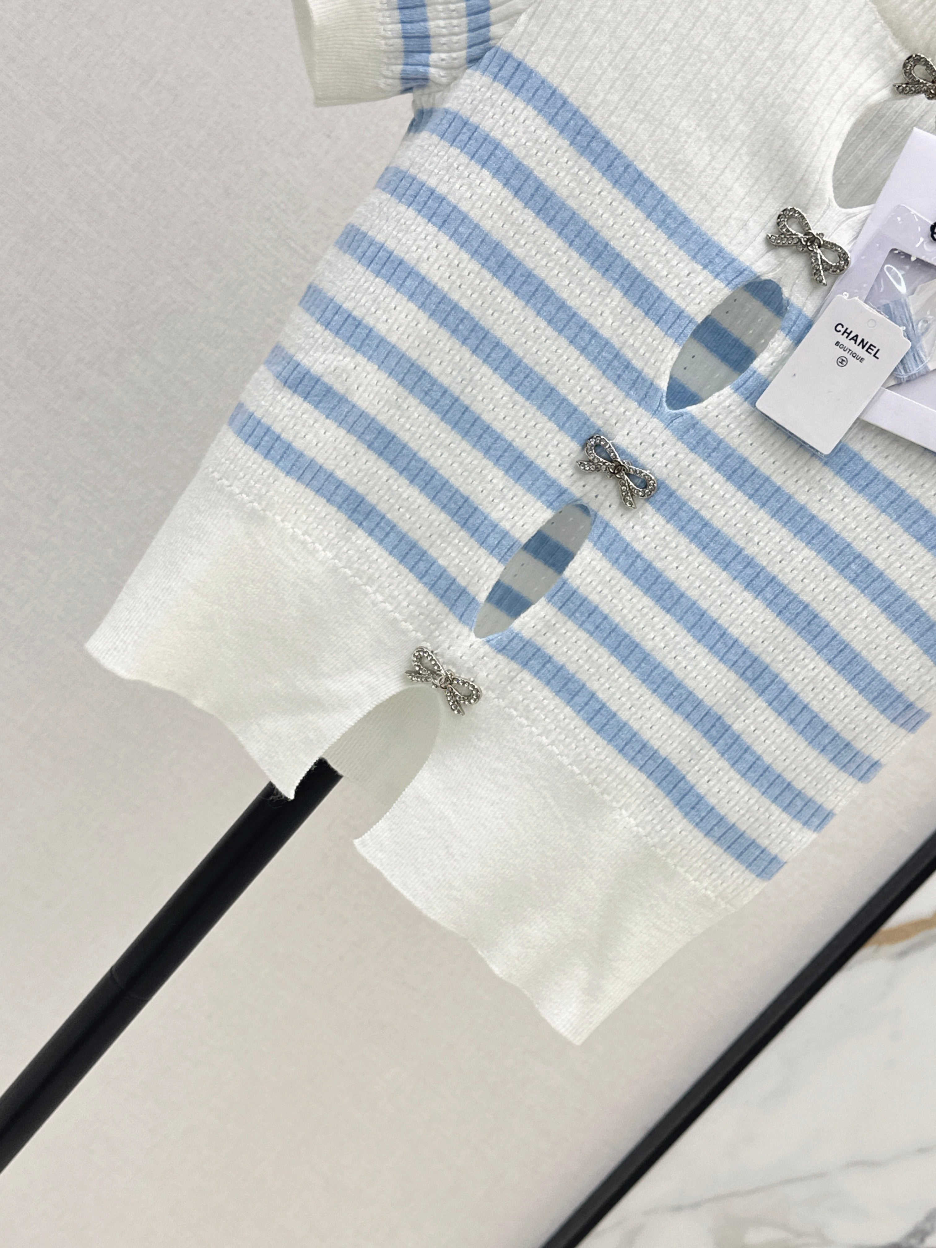 Striped knit top with bow embellishment